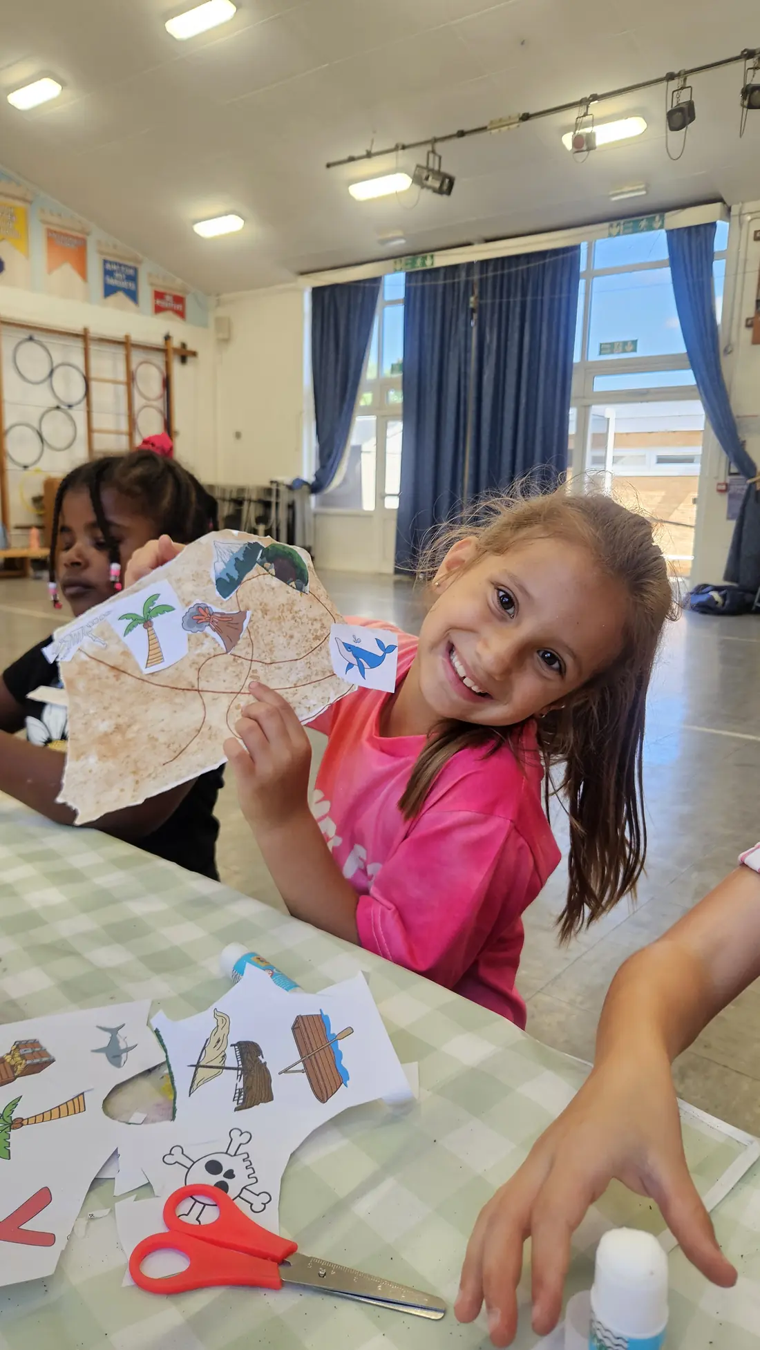Child showing an arts and crafts project at summer camp